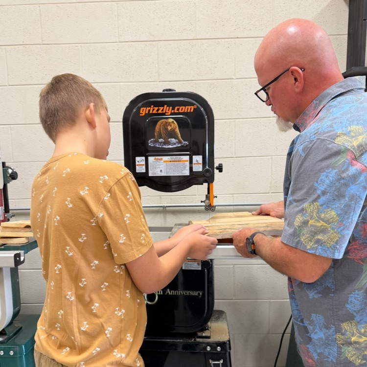 student and teacher working at equipment table