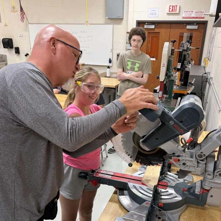 teacher and students working on pumpkin project