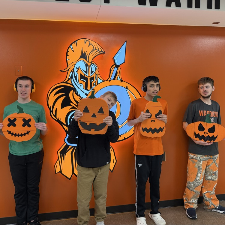 students displaying their pumpkin projects