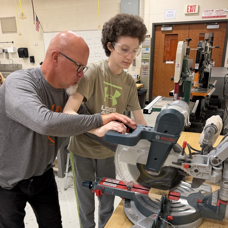 student and staff in woodworking class