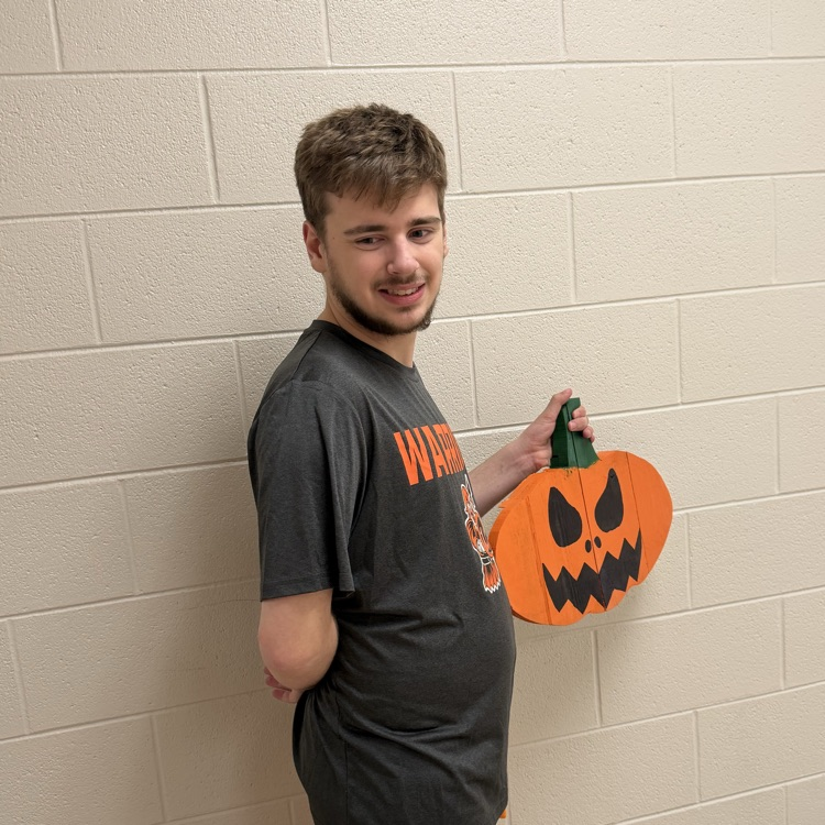 student holding pumpkin project