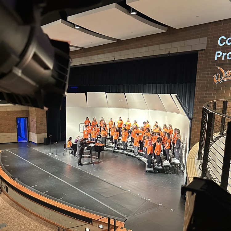 students performing on stage