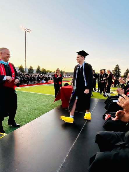 Linden student Eagle Mascot graduating wearing eagle feetwearing