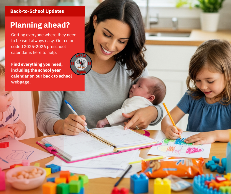 Woman holding a baby and writing in a planner with a preschooler next to her.