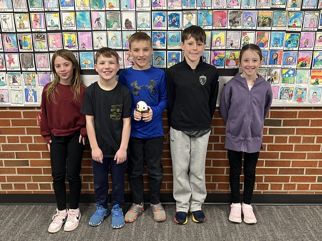 Five elementary students, smiling; three boys and two girls