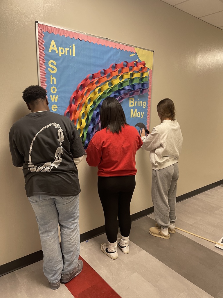 Students creating a Spring Bulletin Board
