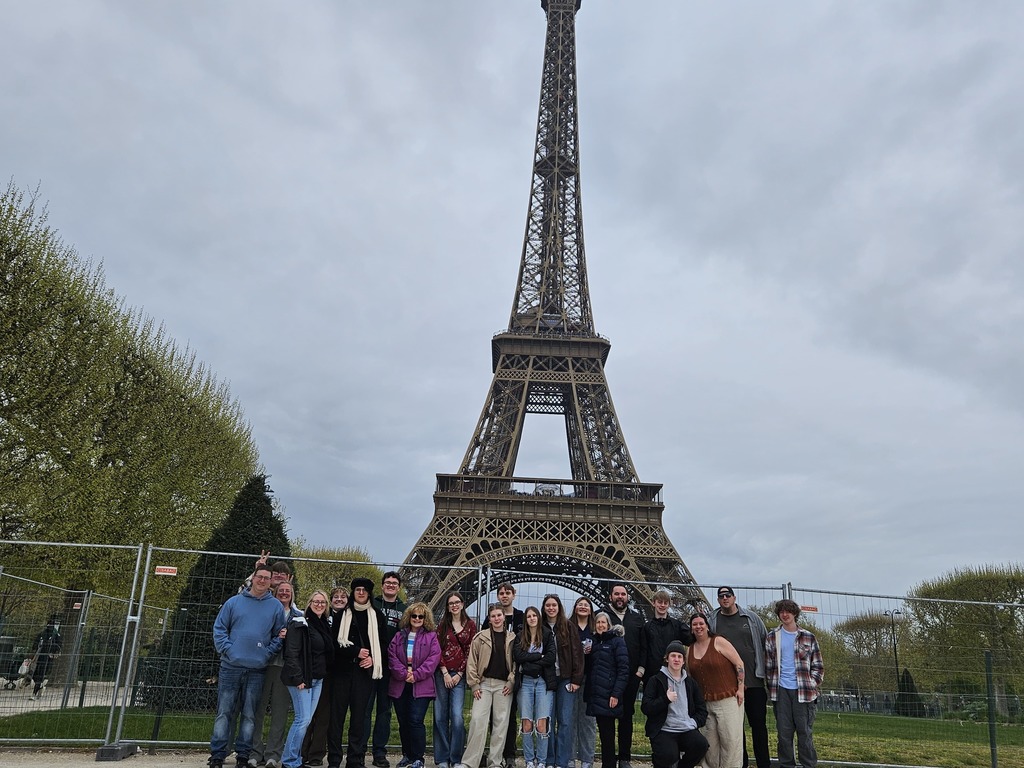 Group of students standing in front of the Eiffel Tower in Paris