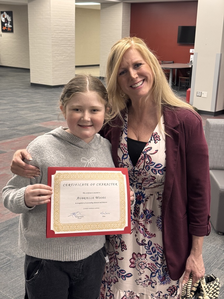 student with teacher, both females.