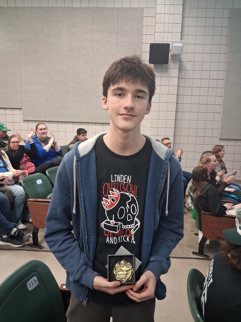 Male Student wearing Quiz Bowl t-shirt