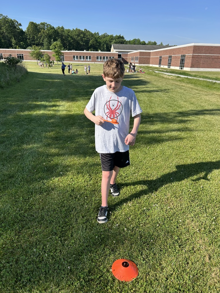 A student playing an egg balancing relay
