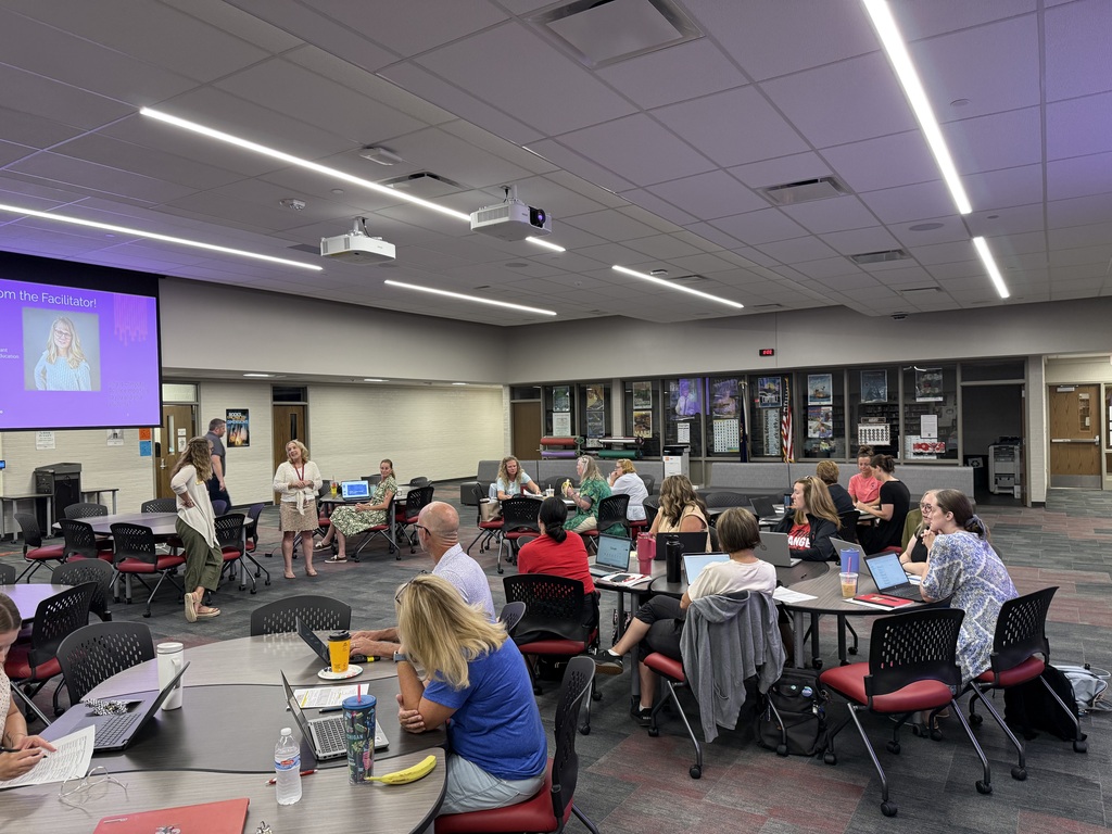 teachers in media center for professional development on computer science