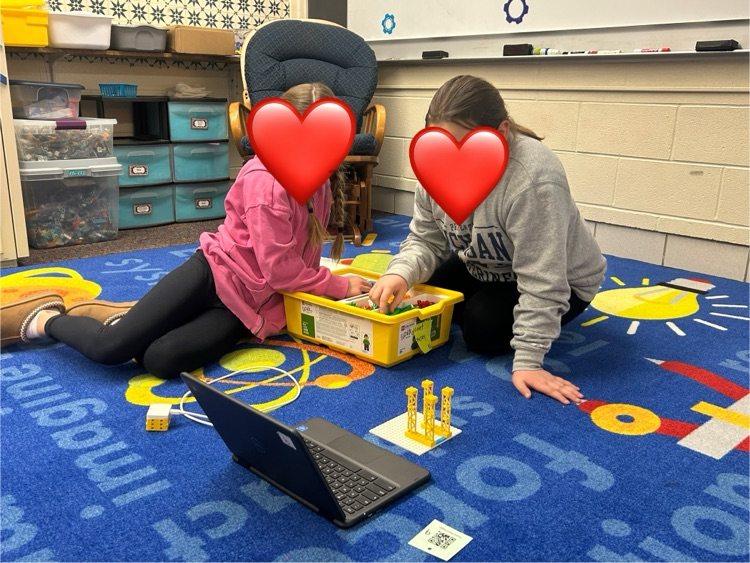 Students working together on Chromebook to code a robot  