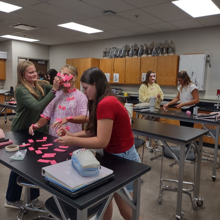 students working any race to label tags with names to body parts