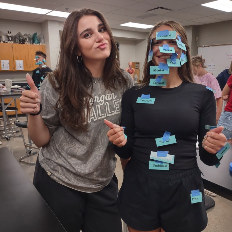 Students smiling after correctly, naming body parts