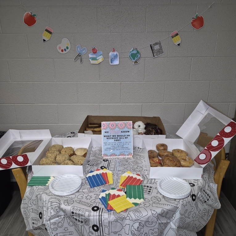 Donut treats with colorful pencil napkins.