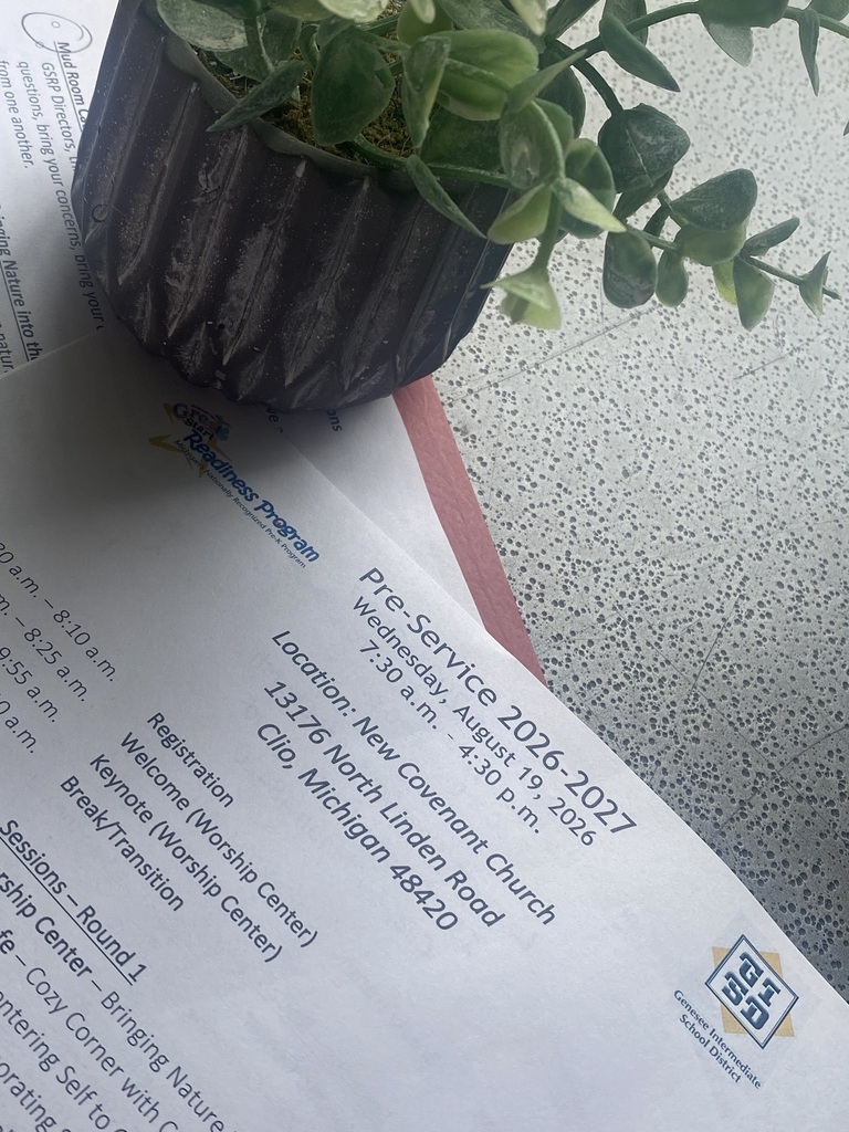 A printed event agenda for the Great Start Readiness Program Pre-Service 2026–2027 rests on a speckled surface next to a small potted plant. The flyer details event info for Wednesday, August 19, 2026, at New Covenant Church in Clio, Michigan, featuring logos for GSRP and the Genesee Intermediate School District.