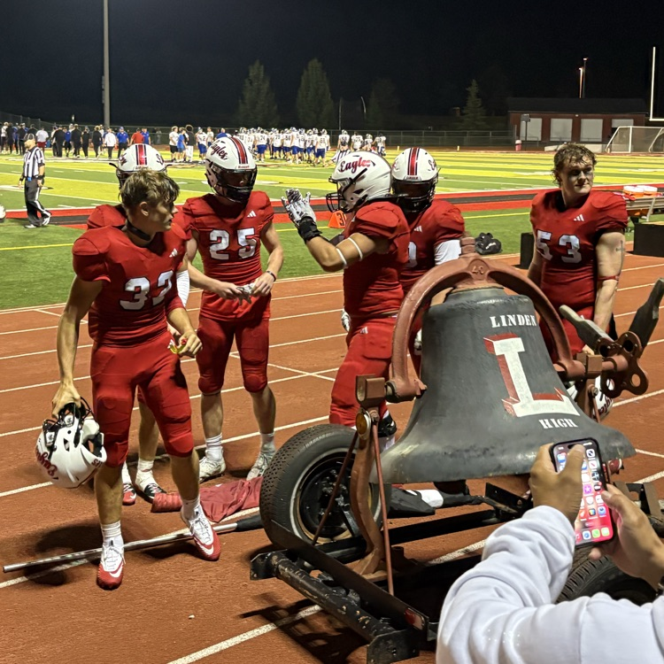 students ringing the bell at the football game 