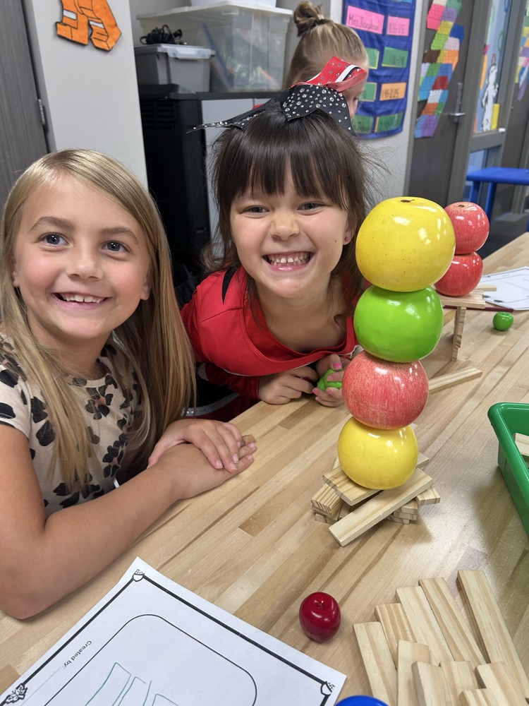 students working together to build a tower