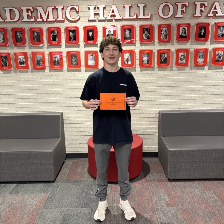 honor roll student with his award