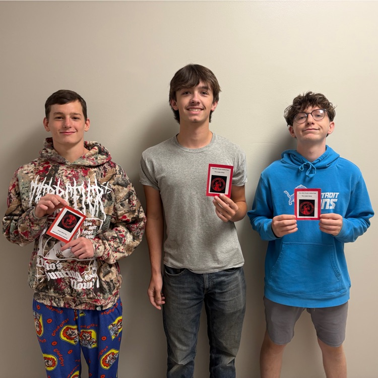 seniors holding pictures of their gift cards
