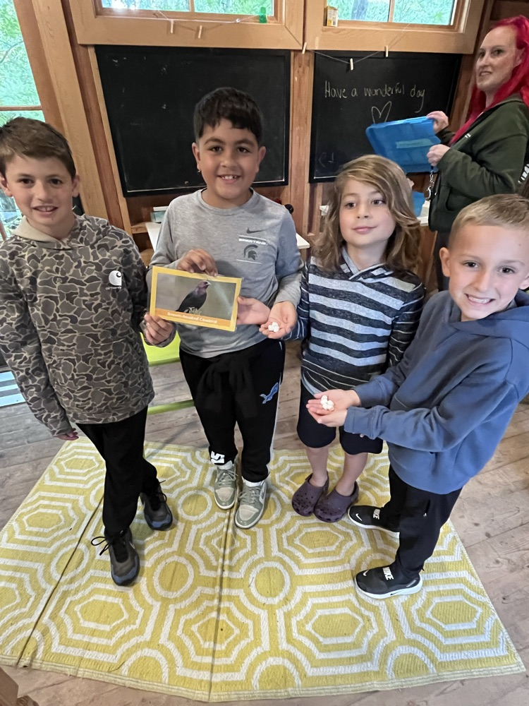 students showing bird card