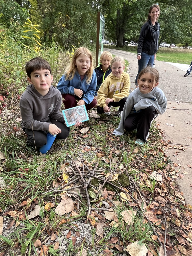 students showing nest they made