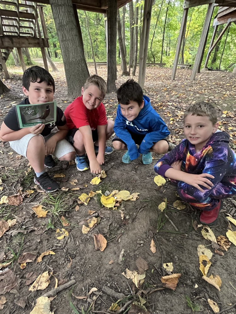 students showing nest they made