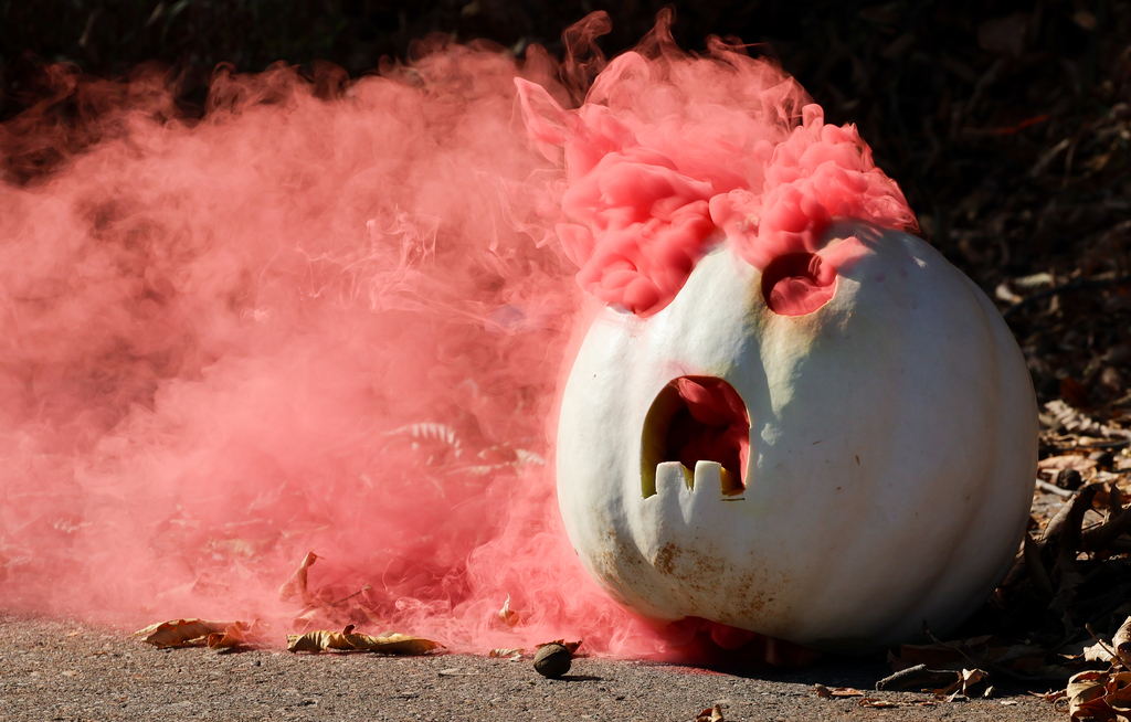 white pumpkin with red smoke coming out