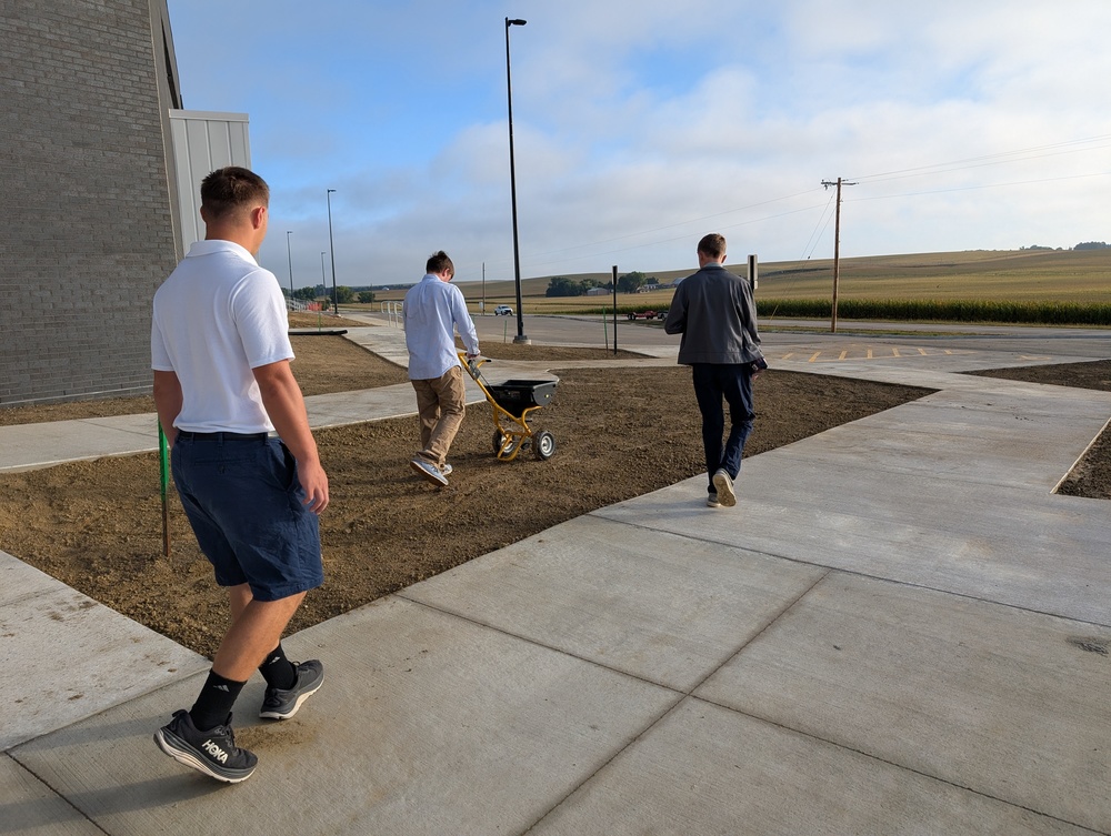 Landscaping students spreading grass seed 