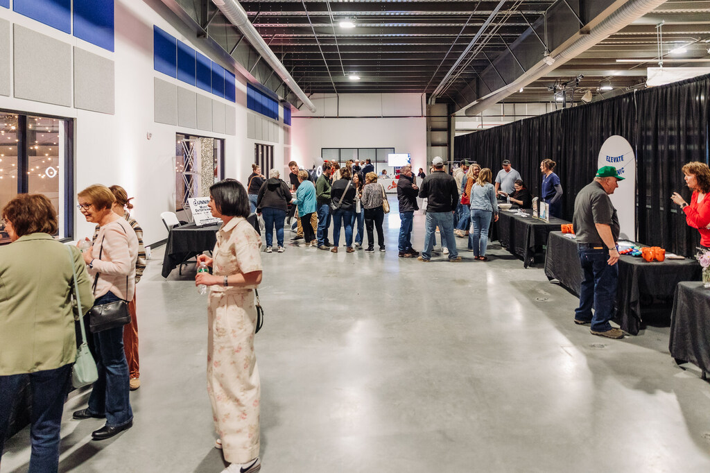 Guests visit with vendors at The Grand Reveal & Event Market.