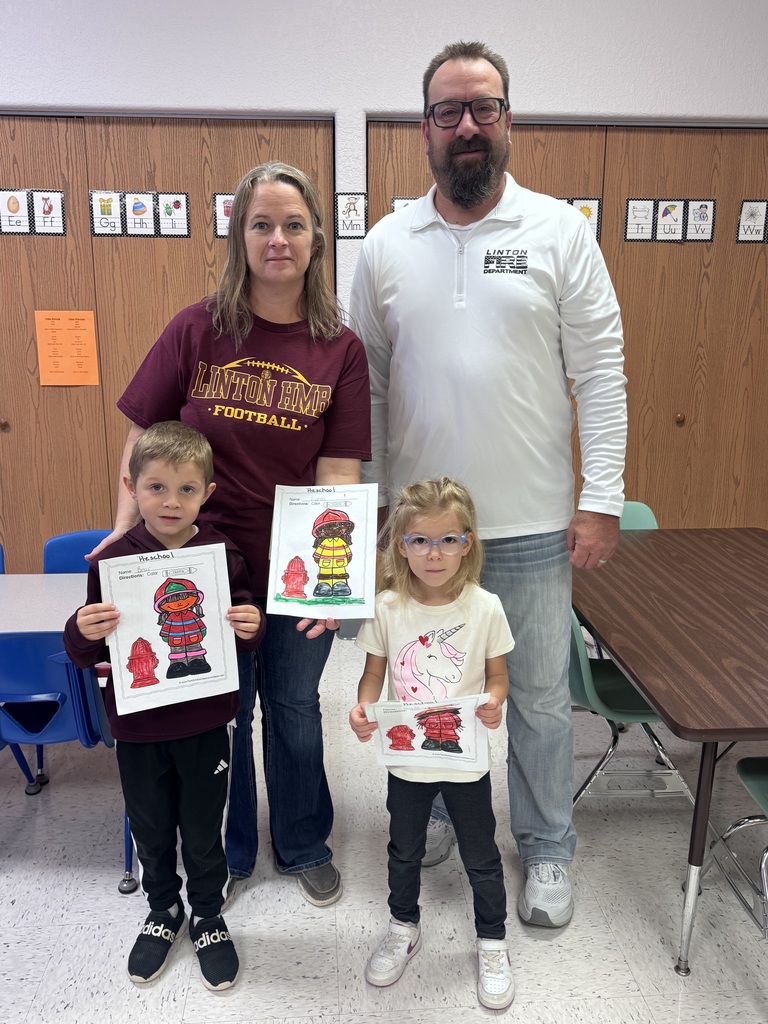 Preschool students participating in the Fire Prevention Week coloring contest pose for a class photo with their awards. First-place winner Bear Bauman and third-place winner Noelle Selzler are pictured. Second-place winner Luella Ohlhauser is not pictured. The contest was sponsored by the local fire department.