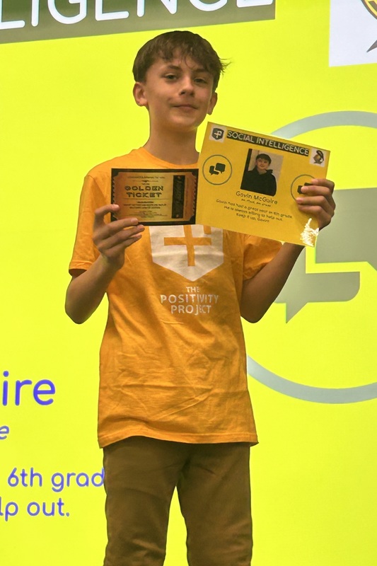 Student posing with their award