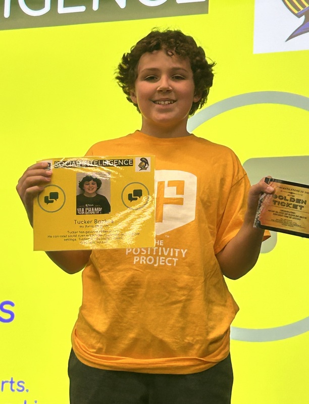 Student posing with their award