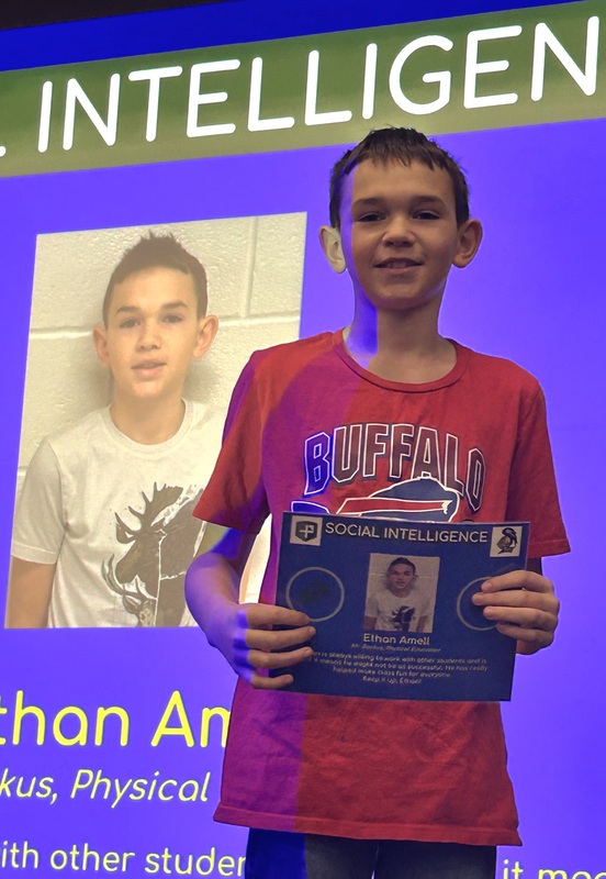 Student posing with their award