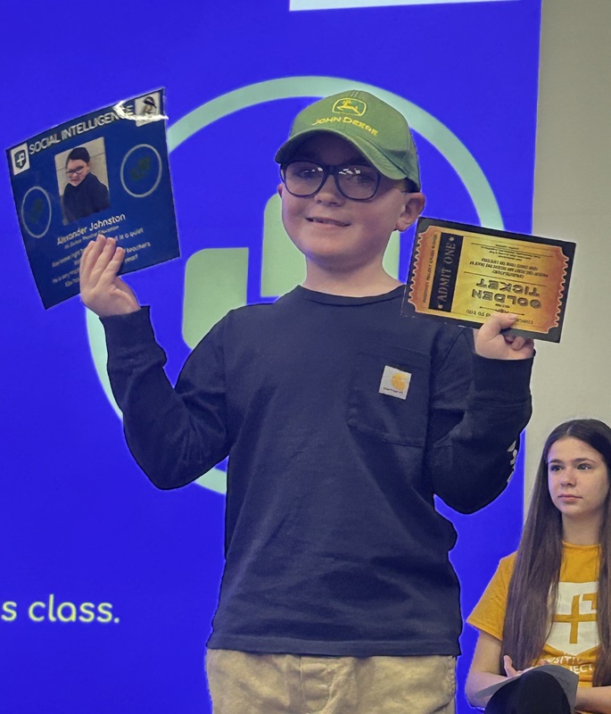 Student posing with their award