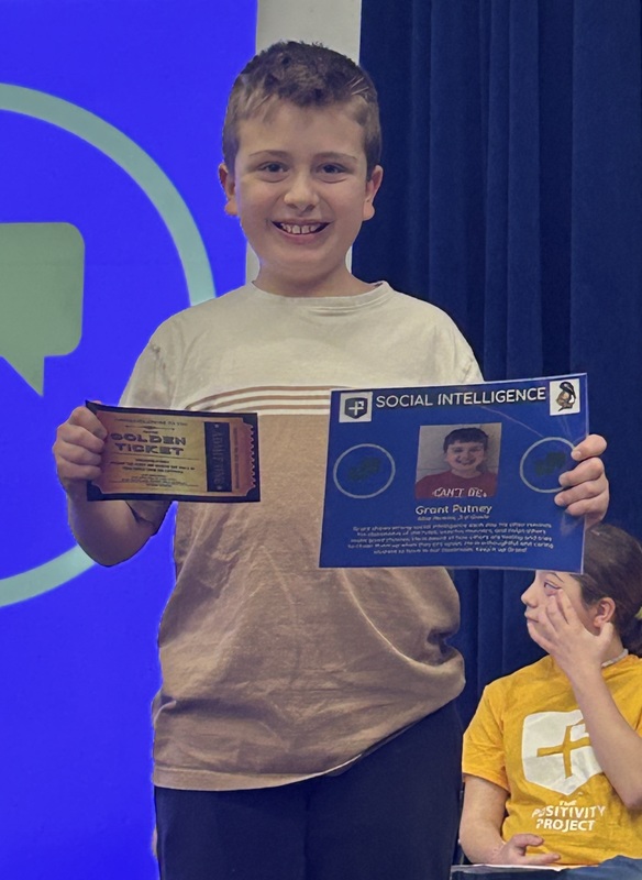 Student posing with their award