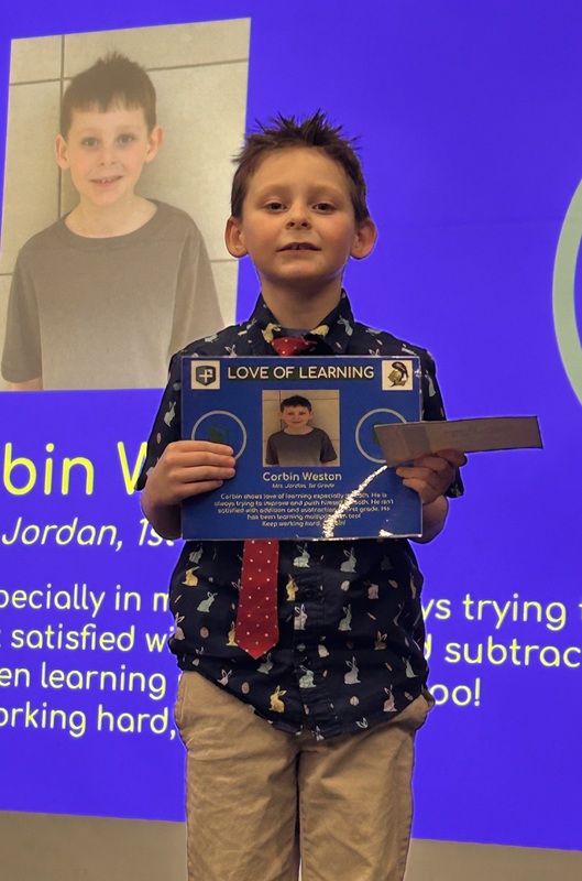 Student posing with their award