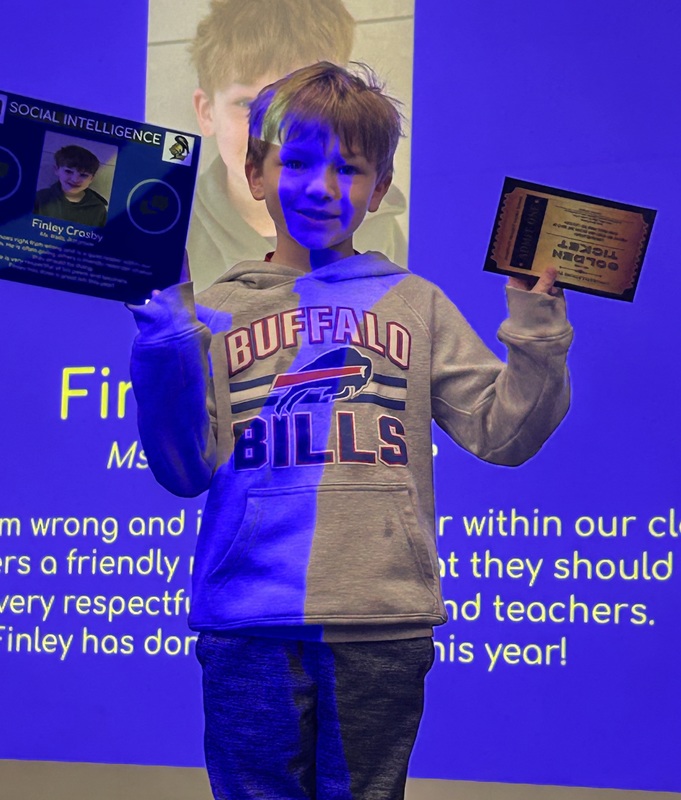 Student posing with their award