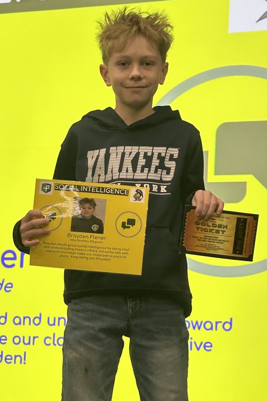 Student posing with their award