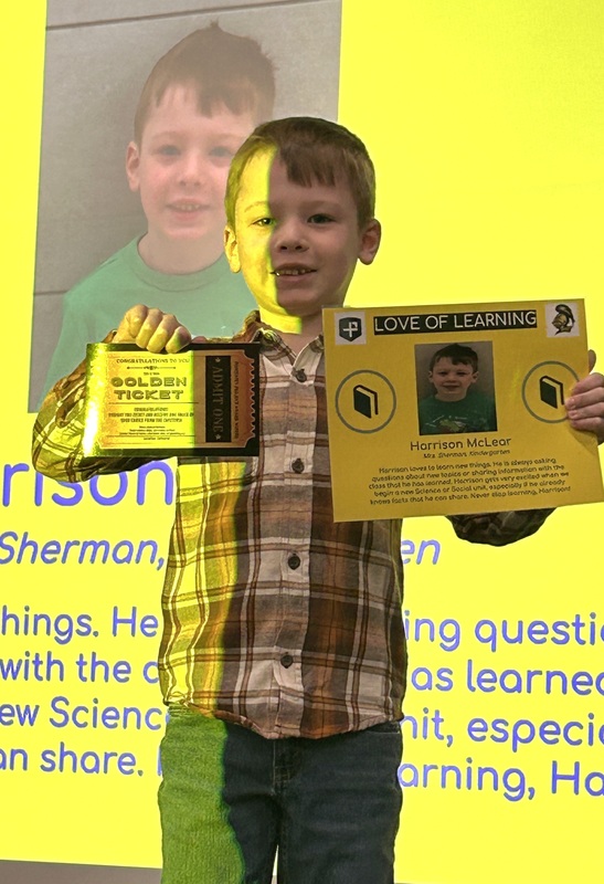 Student posing with their award
