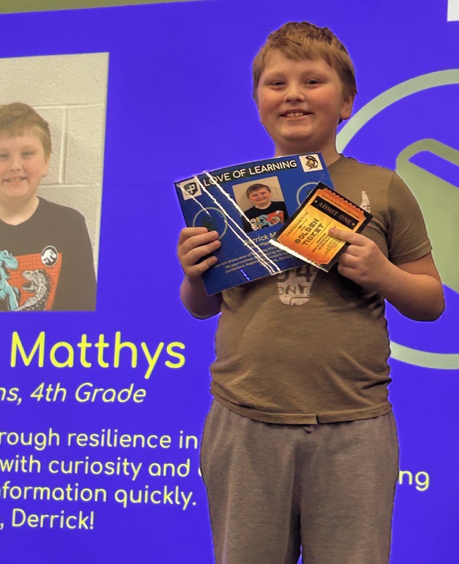 Student posing with their award