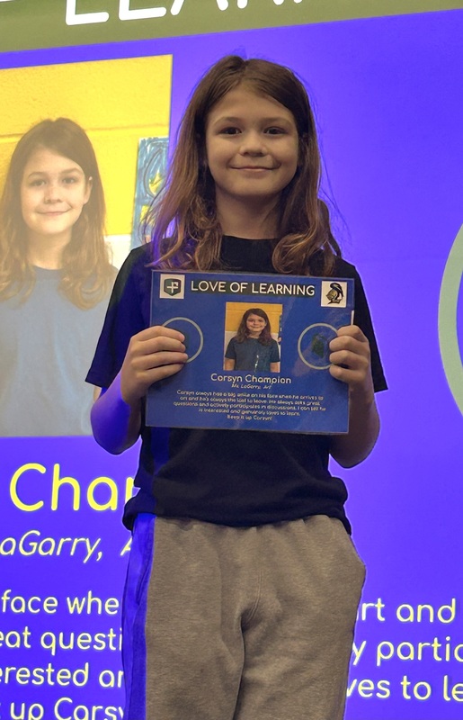 Student posing with their award