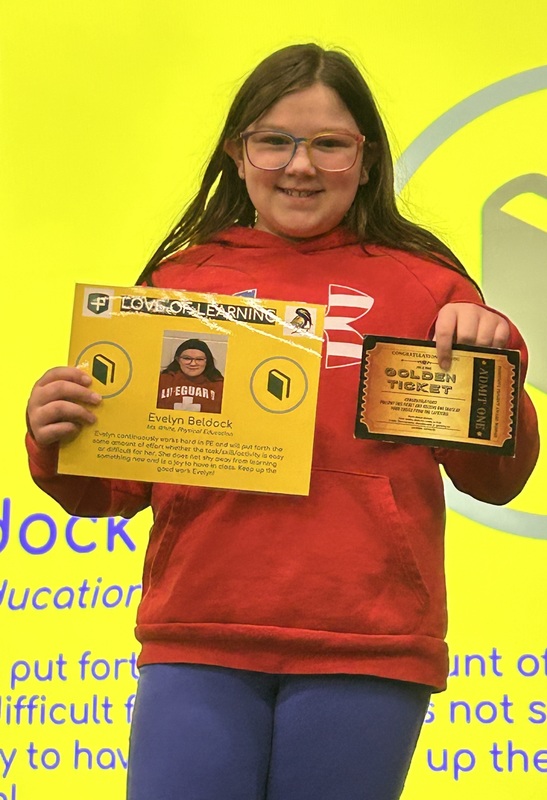 Student posing with their award