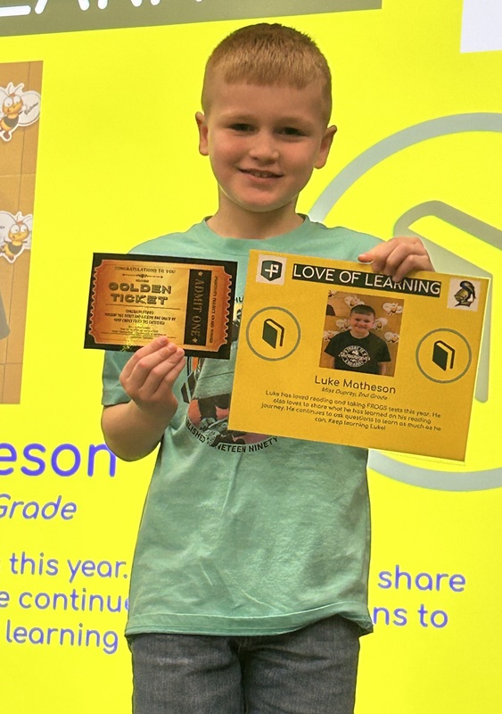 Student posing with their award