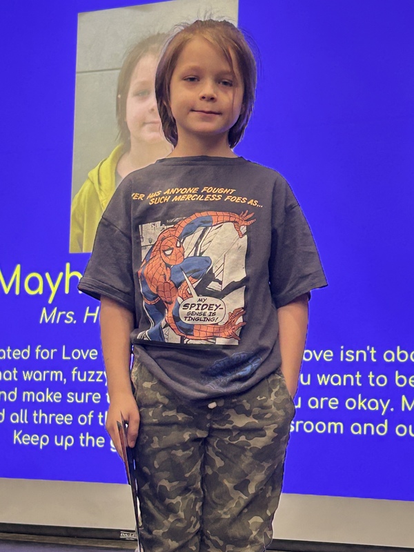 Student posing with their award