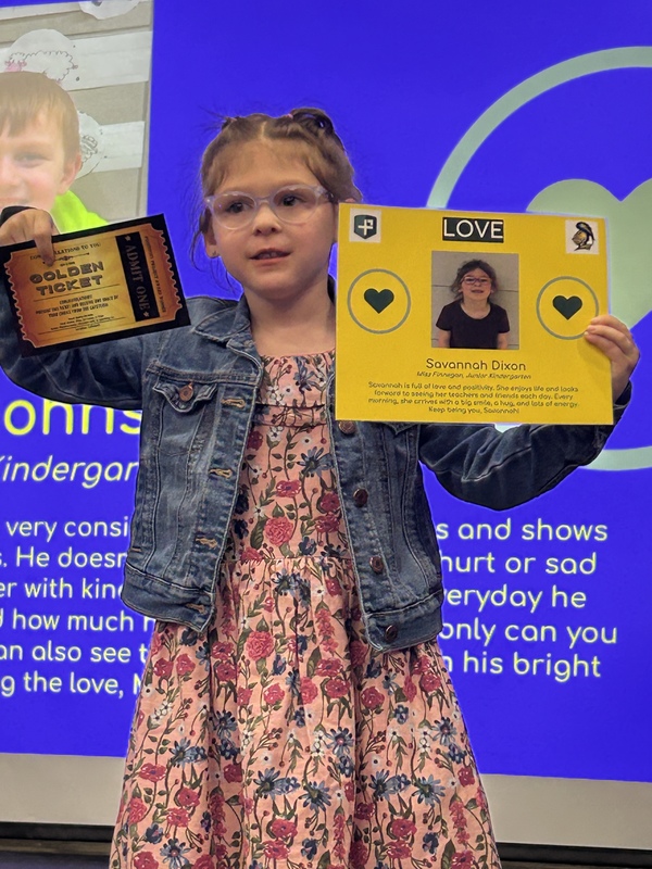 Student posing with their award