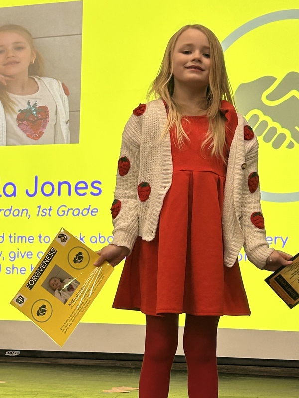 Student posing with their award