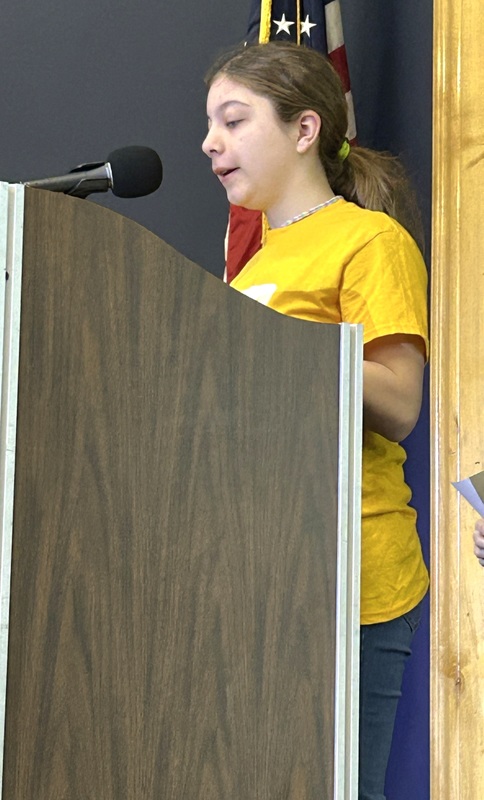 Student presenting at a podium