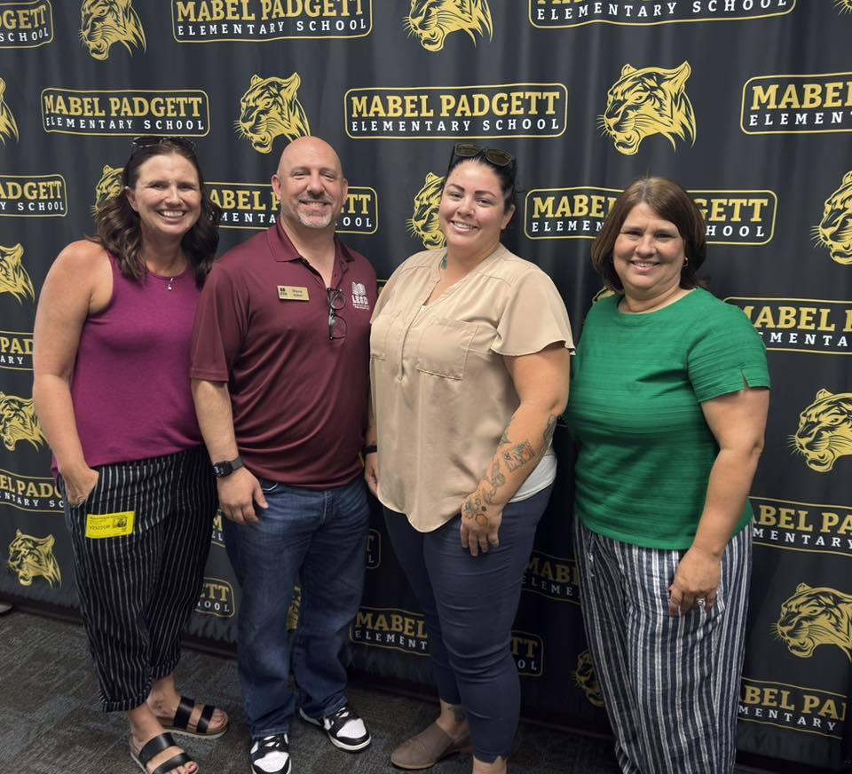 Mrs. Girvan and 3 members from the LESD Foundation pose for a photo