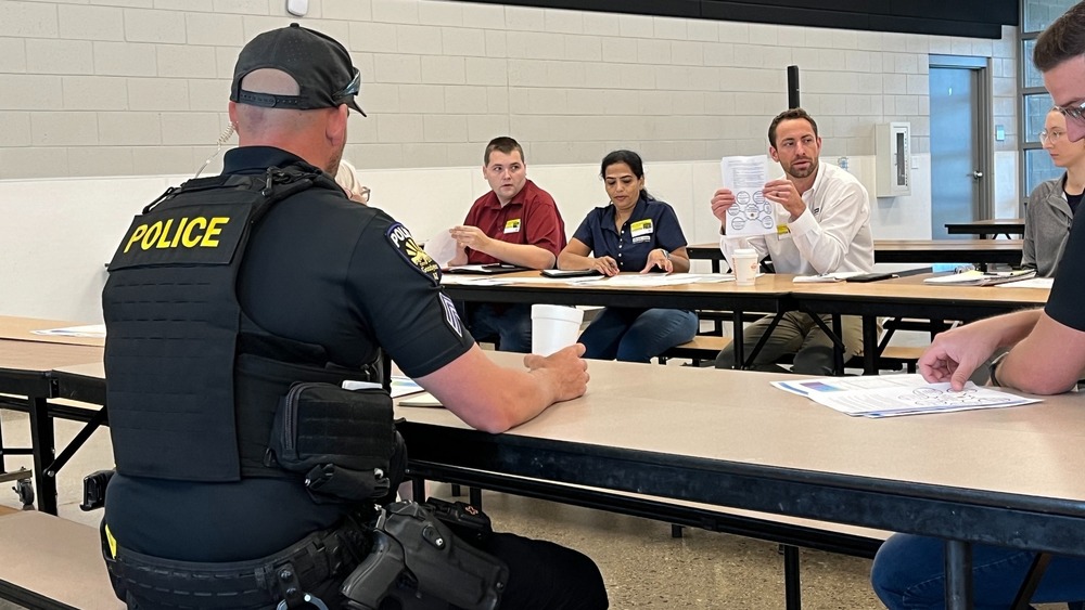 police officer and people sitting at a table